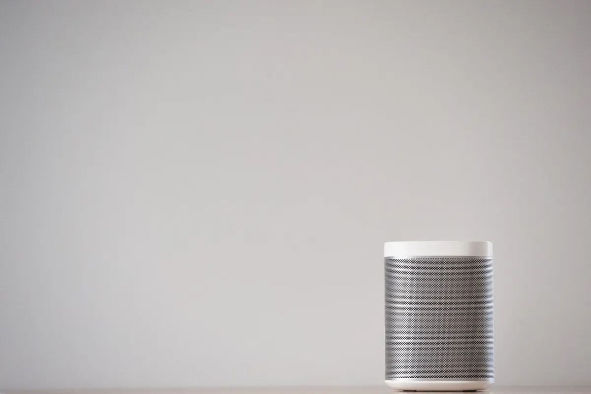 A minimal wireless speaker against a plain wall